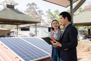 Sustainable business collaboration. Business professionals discussing renewable energy solutions by solar panels. photo