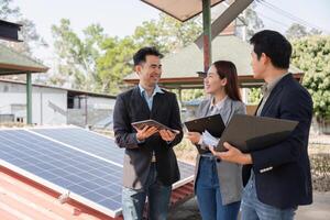 Collaborative energy solutions. Professionals engaged in discussion under solar panels. photo
