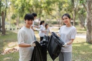 Dedicated young volunteers showcasing their commitment to a cleaner environment during a community cleanup. photo