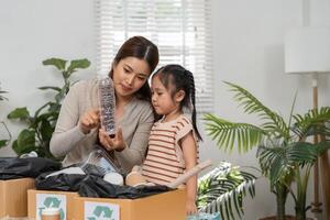 Recycling Awareness and Family Values. A mother and her child exploring the importance of recycling together with various plastic items. photo