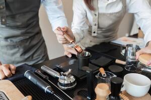Coffee Brewing and Barista Techniques. Two baristas skillfully preparing coffee using specialty tools and techniques. photo