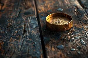 A gold ring sitting on a wooden table photo