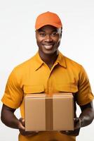 A smiling black man in an orange uniform holding a box photo