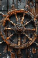 An old ship wheel on a rusty wooden door photo