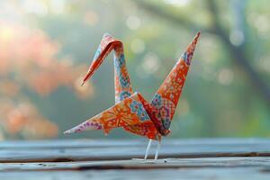 A paper crane is sitting on a table photo