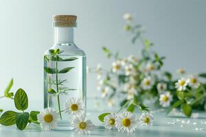 Chamomile oil in a glass bottle with flowers on a blue background photo
