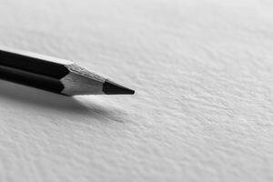 A black and white photo of a pencil on a white surface