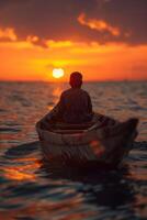 A man in a boat on the ocean at sunset photo
