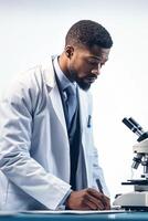 A man in a lab coat is writing on a piece of paper photo