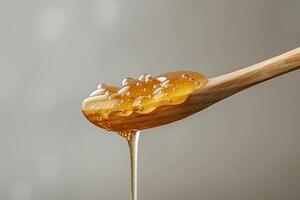 A spoon with honey dripping from it photo