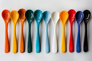 A group of colorful spoons arranged in a row photo