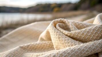 Cozy Knitted Blanket Softly Draped by Lake for Relaxing Outdoor Picnics and Nature Lovers Seeking Comfortable Warmth in Serene Settings photo