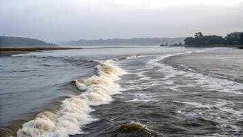 Ocean waves crashing on sandy beach with misty background for nature lovers and photographers photo
