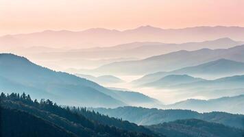 Majestic mountain range with misty layers at sunrise for nature enthusiasts and photographers seeking serene landscapes photo