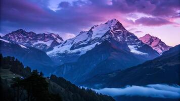 Snowy mountain peaks glowing at sunset in a serene valley for nature enthusiasts and photographers photo