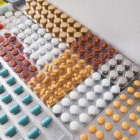 A tray of pills and tablets on a counter photo
