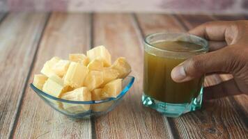 Sugarcane juice and cubes on a table video