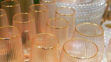 Elegant glasses with gold trim arranged for a fancy gathering video