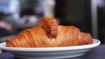 Freshly baked croissant served on a plate in a cafe video