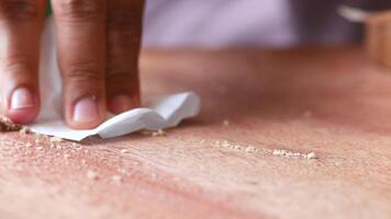 Close-up of cleaning crumbs with a tissue on a wooden table after a meal video