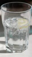 Refreshing drink preparation with ice and lemon in a glass video