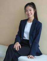 A young asian woman in a business suit sitting on a bench photo