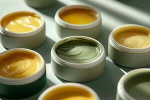Several jars of moisturizing creams in soft green and yellow tones are displayed under gentle lighting, suggesting care, wellness, and natural beauty products photo