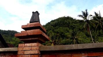 The shape of a beautiful gate in a village with a cliff behind it video