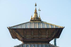A bunk roof and a golden spire on main temple of Pashupatinath in Kathmandu, Nepal. photo