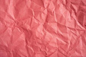 Crumpled red paper sheet texture and background. photo