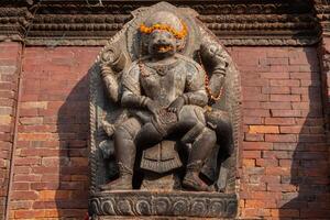 The stone sculpture of Hanuman is a Hindu god whose shape is half-monkey, half-human situated in Patan Durbaq square, Kathmandu, Nepal. photo