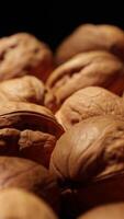 Walnut nuts food, closeup of walnut nut texture on black background video