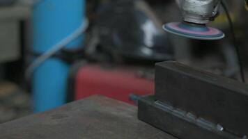 Spectacular slow motion footage using the flexible disc grinder on a metal bar, as the tool touches the surface numerous orange sparks are projected. Metal processing in the workshop. video