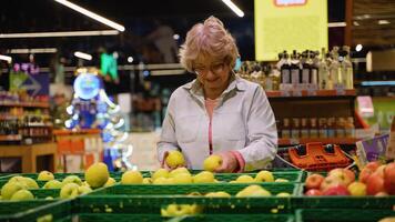 Senior Woman Selecting Fresh Apples at Grocery Store video