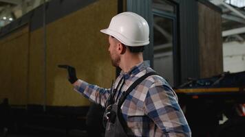 Worker with radio supervising SIP panel house loading video