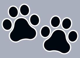 Two black and white paw prints on a gray background vector