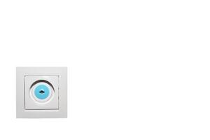 Electrical socket on white wall with plug and child protection. Copy space. photo