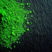 Moringa powder spread on a textured dark surface photo