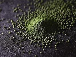 Moringa powder displayed on a dark surface with texture details photo