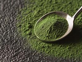 Moringa powder close-up on a dark textured surface photo
