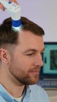 Man with hair loss at trichologist appointment for scalp check video