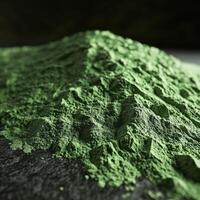 Moringa powder pile showcasing vibrant green color and texture photo