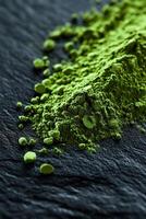 Moringa powder with vibrant green color on dark background photo