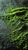 Moringa powder spread on a dark surface showcasing its vibrant color photo