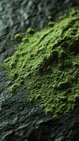 Moringa powder displayed on a dark stone surface for health benefits photo