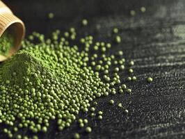 Moringa powder scattered from a wooden container on dark surface photo