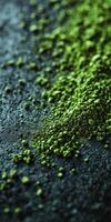 Moringa powder scattered on a dark surface highlighting its color photo