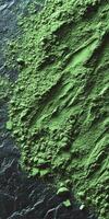Moringa powder on dark surface with textured patterns photo
