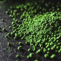 Moringa powder scattered on a dark surface for healthy cooking photo