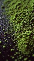 Vibrant green moringa powder on a dark surface photo